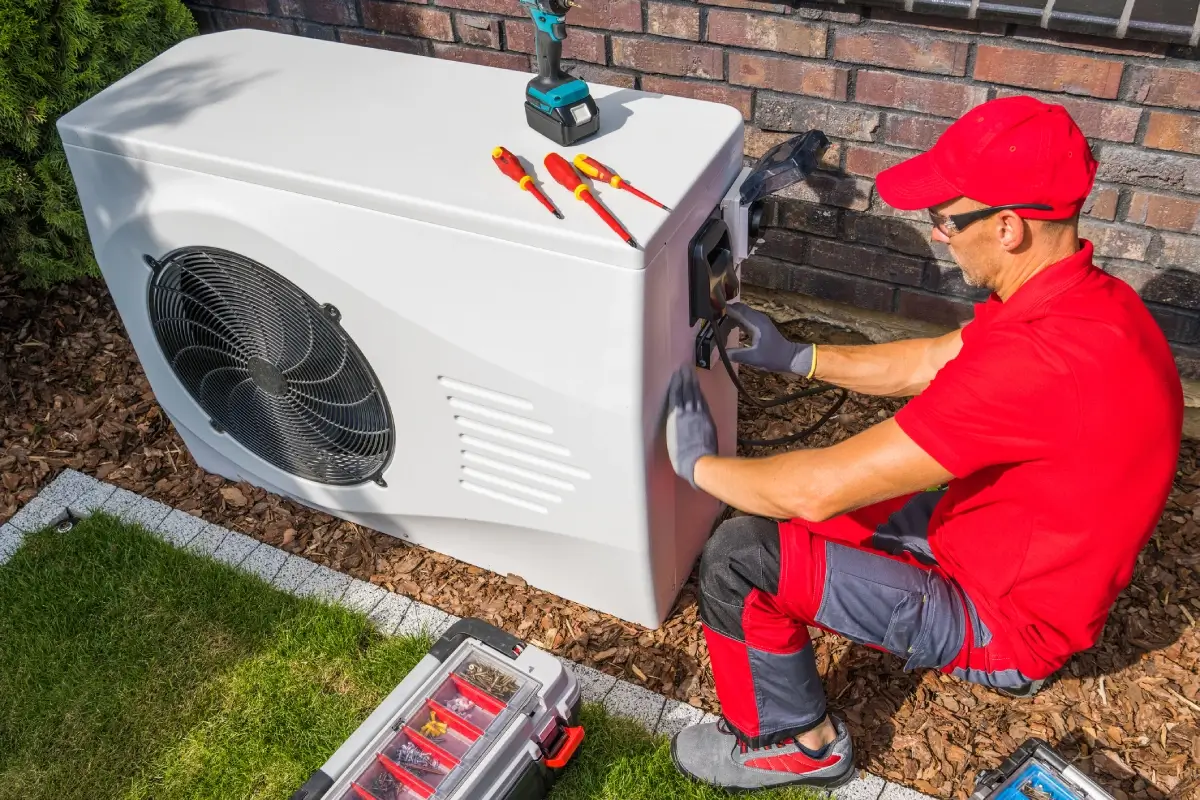 Technician working on outdoor AC unit.