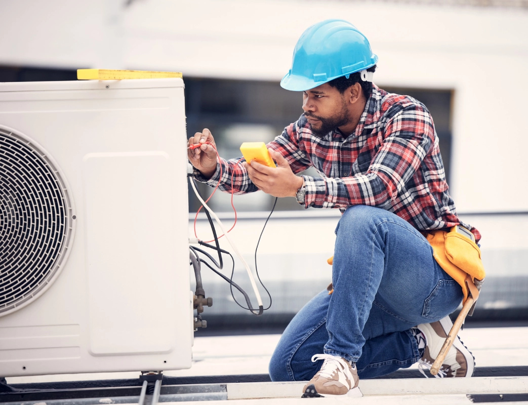 Technician inspecting an AC unit.