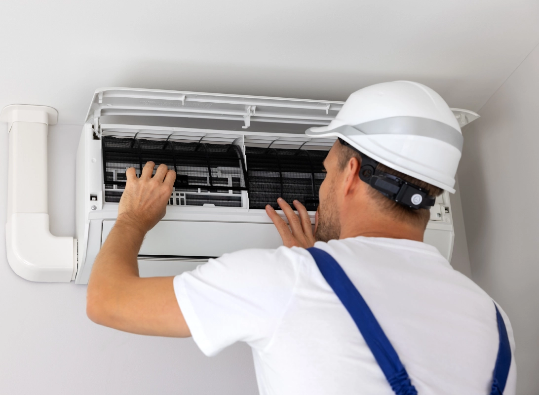 Technician repairing air conditioner filter.